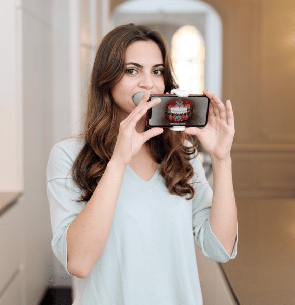 woman holding dental monitoring camera