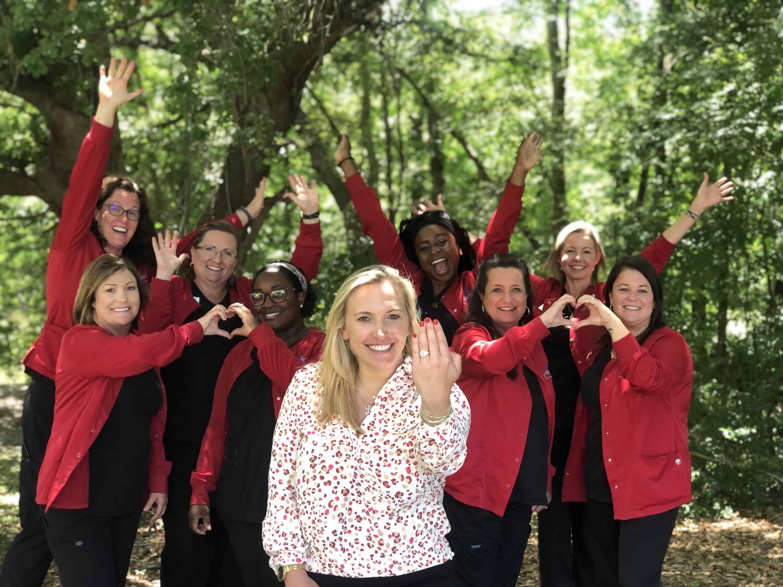Grosso-orthodontics-team-celebration-engagment Grosso orthodontics team celebrating outside group photo engagement happy smiling