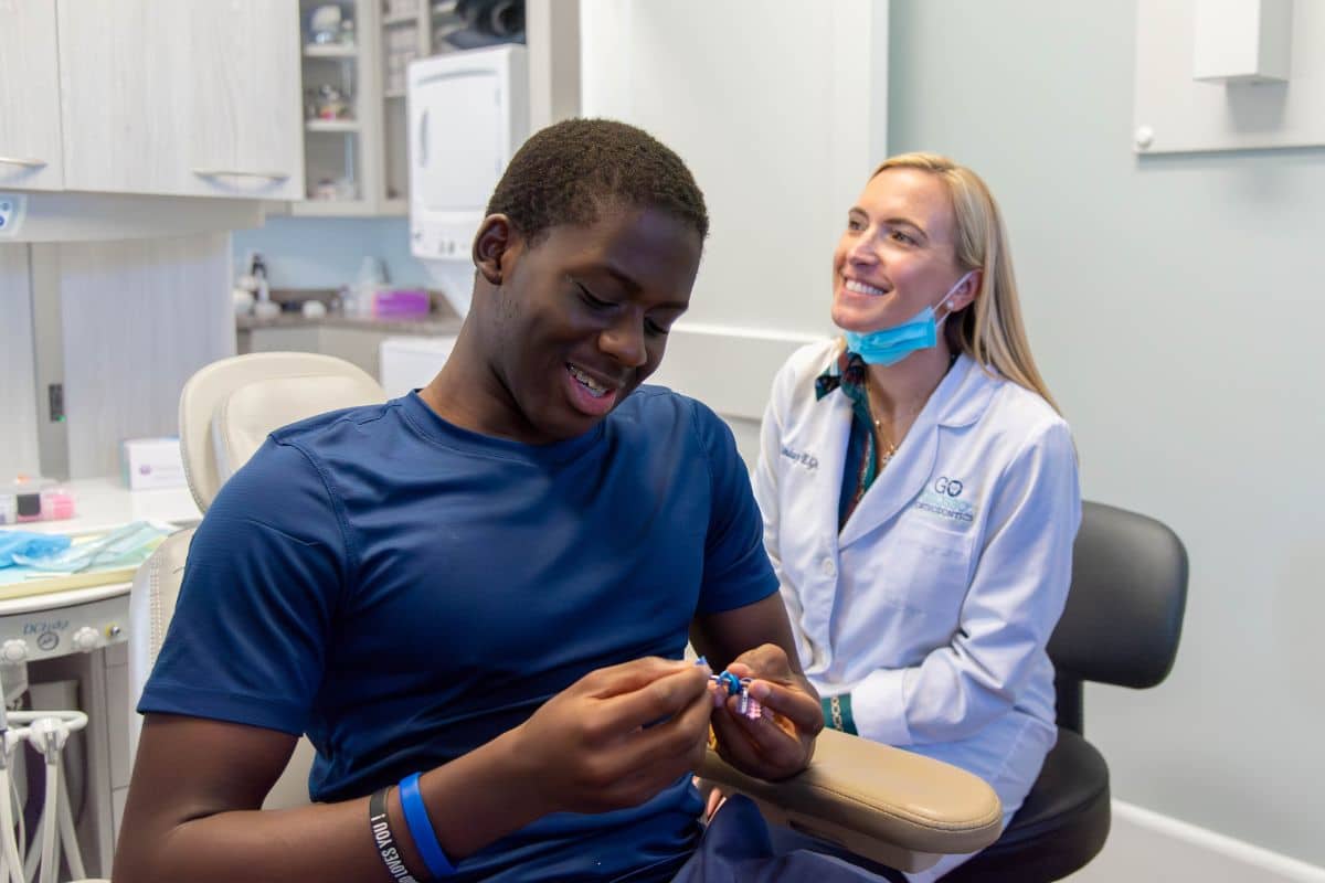 Grosso-orthodontics-traditional-braces Patient choosing colorful rubber bands for traditional braces at grosso orthodontics in south carolina
