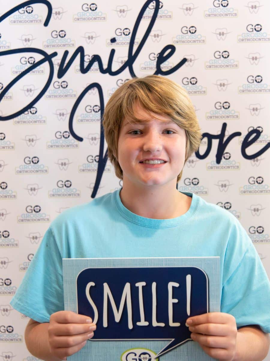 Kid smiling after completing braces treatment and ready for retainers at grosso orthodontics in south carolina